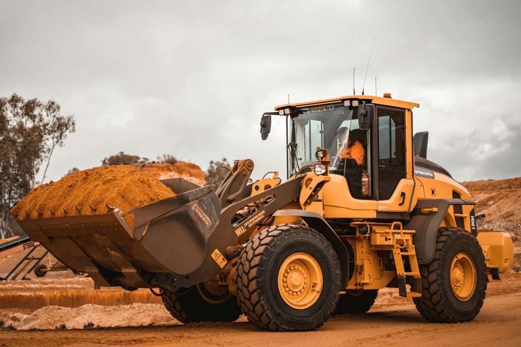 Excavator in operation, illustrating the benefits of upgrading old machinery for better productivity.