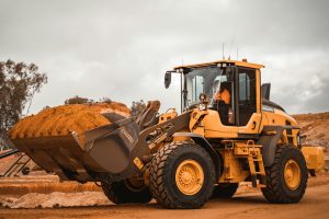 Excavator in operation, illustrating the benefits of upgrading old machinery for better productivity.